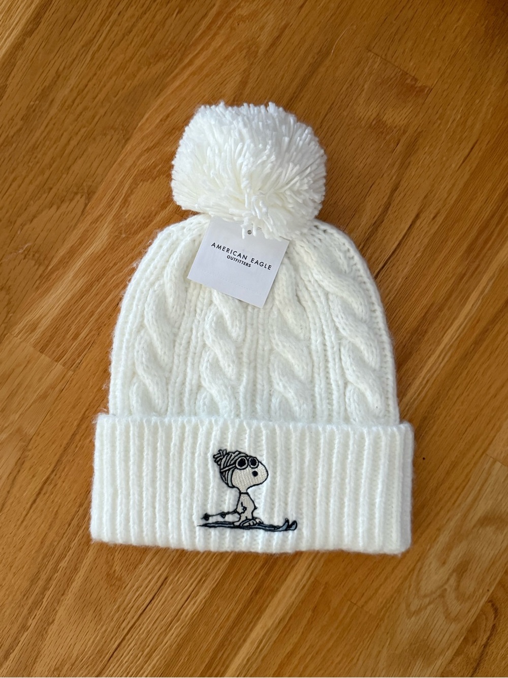 American Eagle Outfitters Cream Cable Knit Pom Beanie with Snoopy Patch
